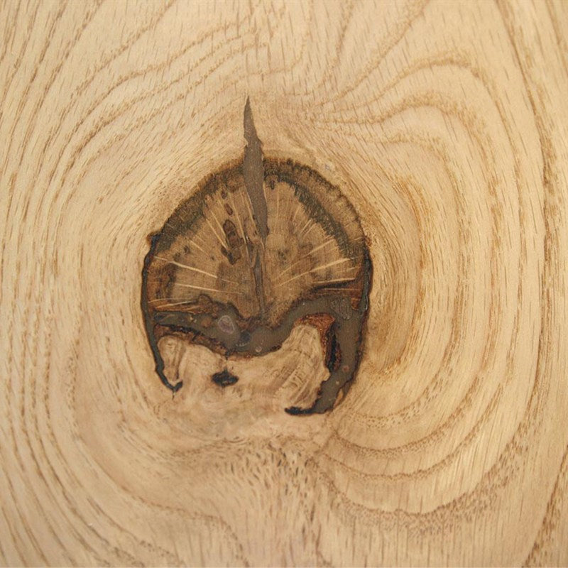 Knot in walnut filled with a warm color-matched walnut filler that blends into the grain