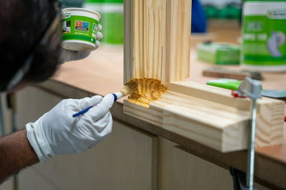 DRY FIX UNI primer being brushed into a wooden window frame