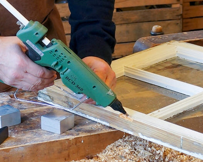 White Knot Filler repairing a defect in a painted window frame