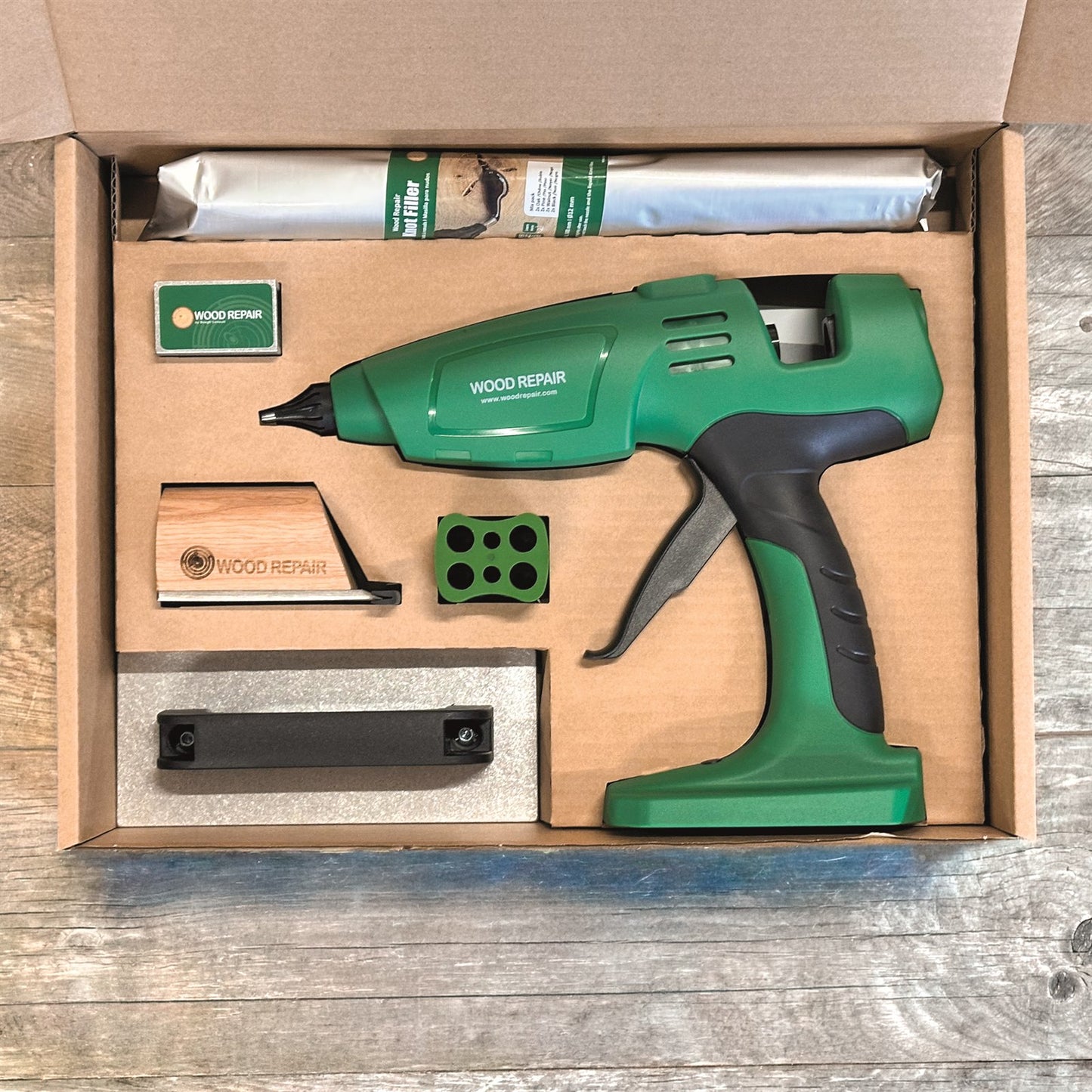 Wood Repair PRO Cordless Kit contents laid out: cordless gun, sticks, cooling iron, brick, cutting tool and saver