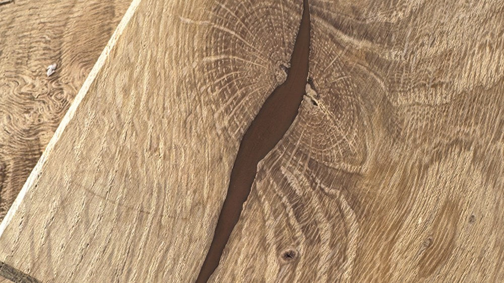 Oak board after Wood Repair: the open knot filled with color-matched filler, sanded flush and nearly invisible