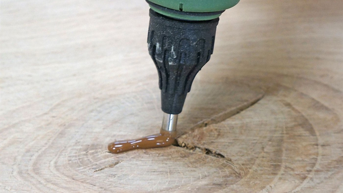 Wood Repair step 1, Fill: Melt the filler straight into the crack.