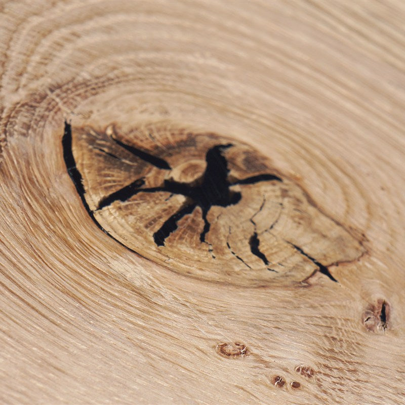 Black filler matched into a wood knot, sanded flush
